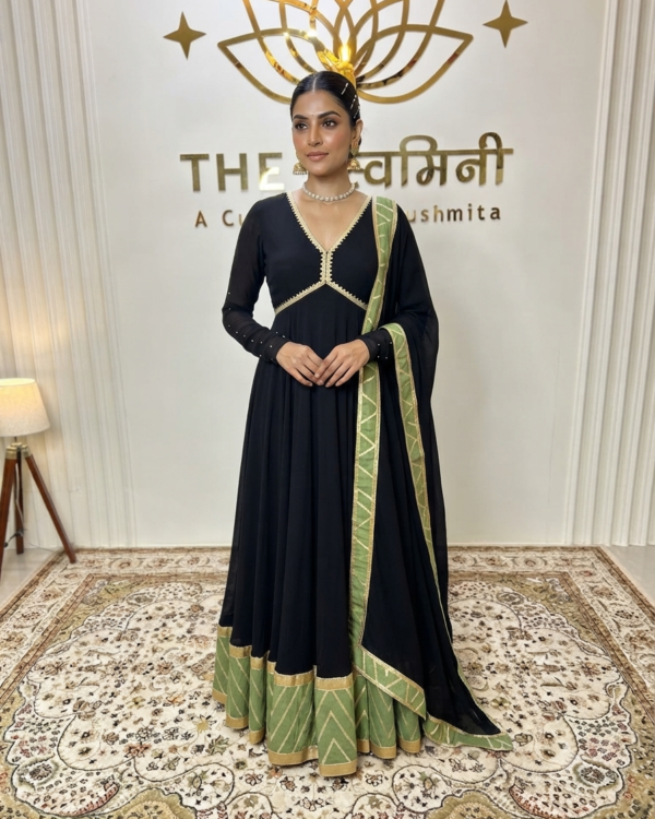 Indian model wearing a sophisticated black georgette suit set accented with a rich green brocade border and a flowing chinon chiffon dupatta by The Swamini by Sushmita.