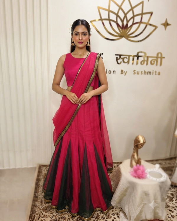 An Indian model wearing The Swamini by Sushmita's pink and green short kali organza fabric dress featuring intricate panels and elegant craftsmanship.