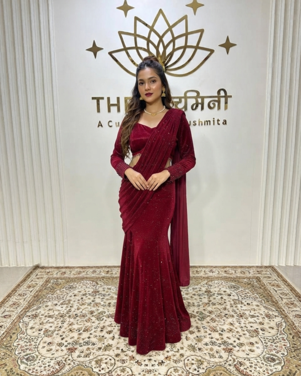 An Indian model wearing The Swamini by Sushmita's luxurious red velvet skirt saree set featuring a rich embellished blouse and a graceful draped pallu.