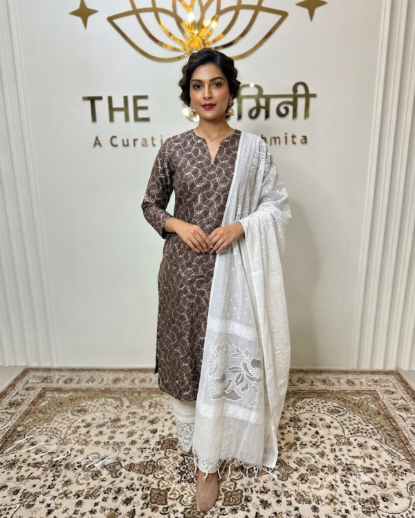 Indian model wearing a classic straight suit featuring intricate Gota design detailing, paired with matching straight palazzo pants and a coordinated dupatta by The Swamini by Sushmita