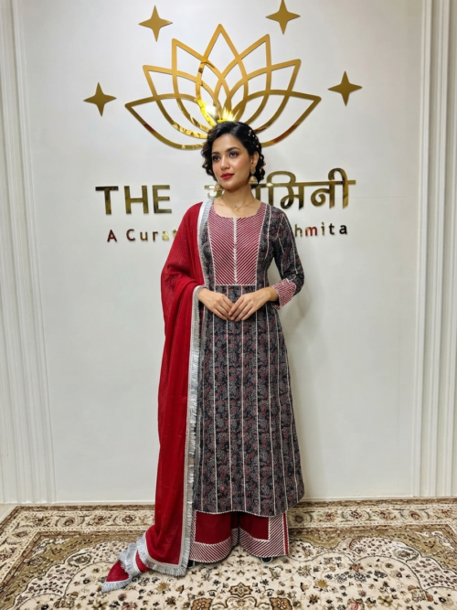 Indian model wearing a traditional Ajrakh fabric straight suit with intricate Gota work, paired with matching straight pants and a rich red dupatta by The Swamini by Sushmita.