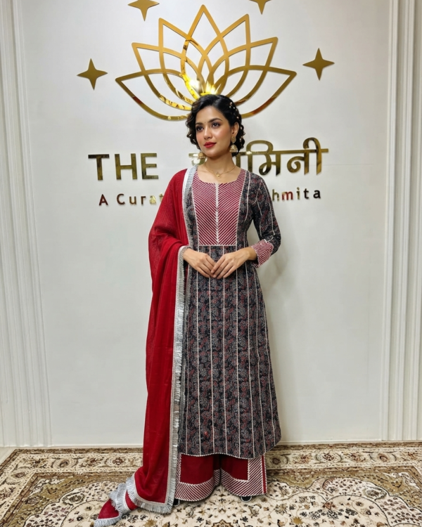 Indian model wearing a traditional Ajrakh fabric straight suit with intricate Gota work, paired with matching straight pants and a rich red dupatta by The Swamini by Sushmita.