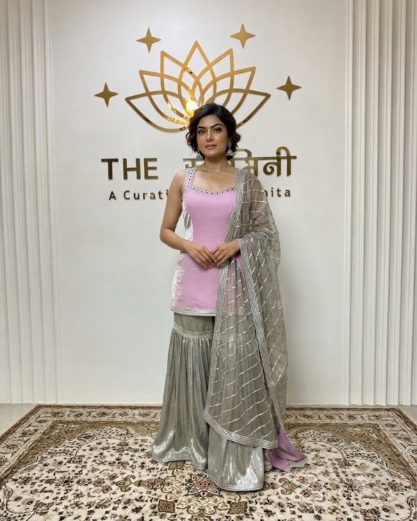 Indian model wearing a chic pink short kurti paired with a metallic silver garara and an embroidered gota work dupatta by The Swamini by Sushmita.