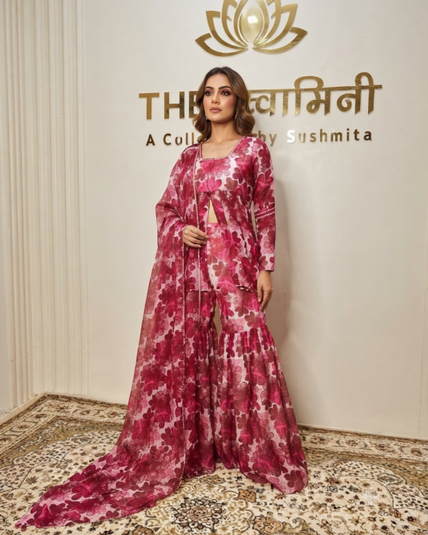 A model wearing a printed Mal and soft Chanderi peplum top, gharara pants, and matching dupatta in a designer studio.
