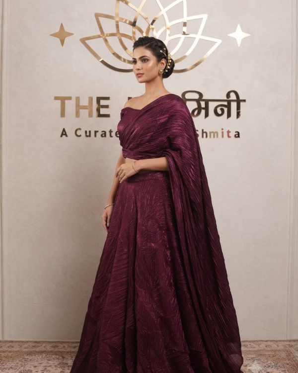 Model wearing a stunning maroon Indo-Western cape lehenga set with a matching crop top and flared skirt.