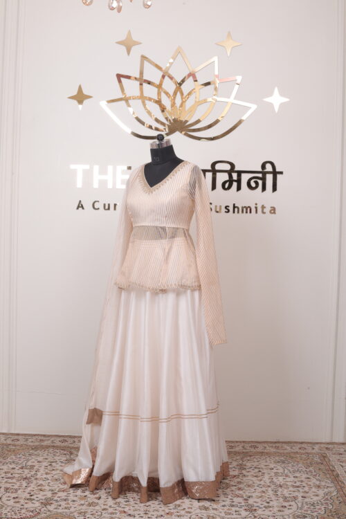 Wide golden zari border on the flare of an ivory Chanderi festive lehenga skirt.