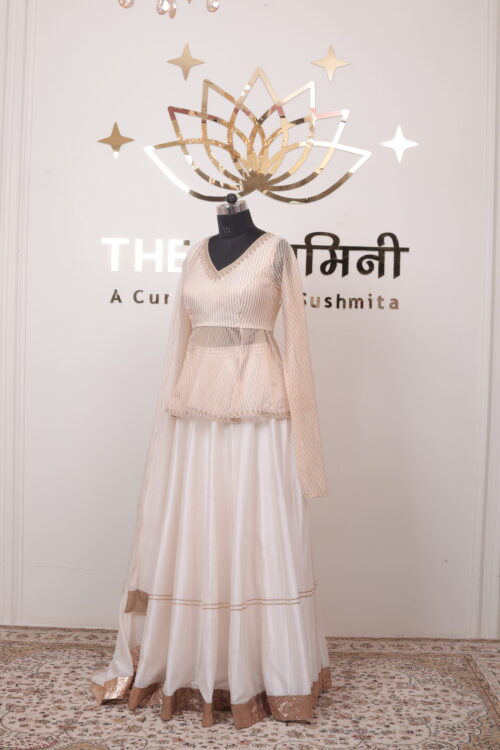Wide golden zari border on the flare of an ivory Chanderi festive lehenga skirt.