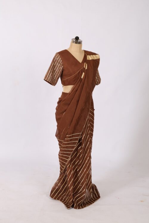 Side profile look of dark brown saree with diagonal heavy gotta patti work and pleated fall